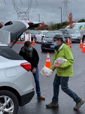 Volunteers getting donations from a car