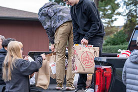 kids unloading food bags from pickup