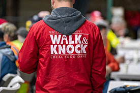 Volunteer wearing Walk & Knock jacket
