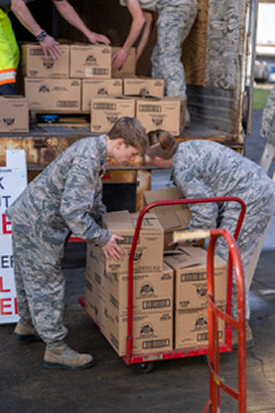 Volunteers loading food into boxes